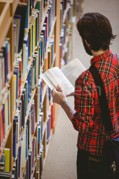 Student picking a book from shelf in library Stock photo © wavebreak_media