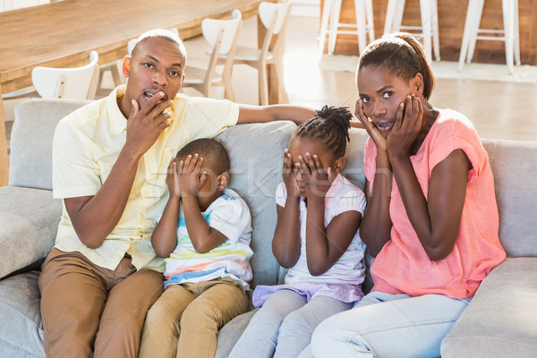 Portrait famille quatre regarder tv salon [[stock_photo]] © wavebreak_media