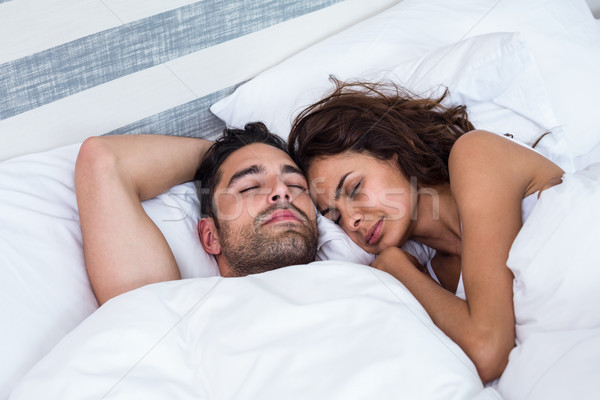 Couple with eyes closed while sleeping on bed Stock photo © wavebreak_media