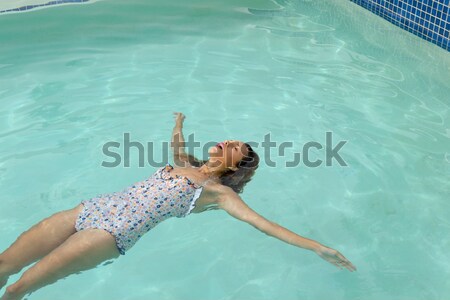 Gyönyörű nő fehér bikini lebeg úszómedence napos idő Stock fotó © wavebreak_media
