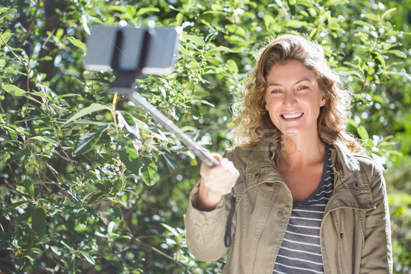 Smiling woman taking selfies Stock photo © wavebreak_media