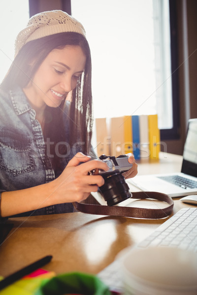 Graphic designer looking at pictures in digital camera Stock photo © wavebreak_media