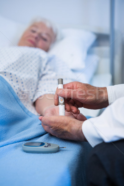Doctor testing diabetes of senior patient with insulin pen Stock photo © wavebreak_media