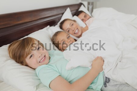 Smiling doctor playing with a little boy and his mother Stock photo © wavebreak_media