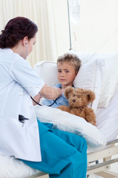 Female doctor listening to a child chest with stethoscope Stock photo © wavebreak_media