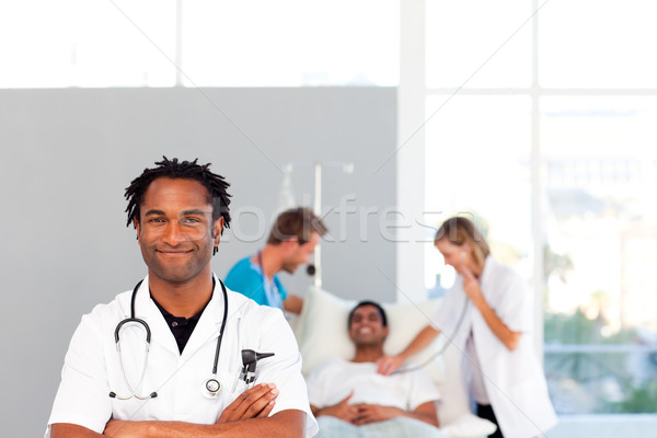 Doctor with folded arms looking at the camera with copy-space Stock photo © wavebreak_media