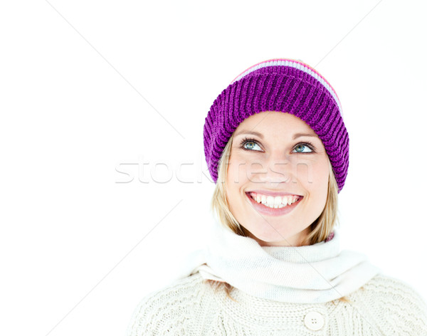 Stock photo: Bright young woman with cap in the winter smiling at the camera against a white background