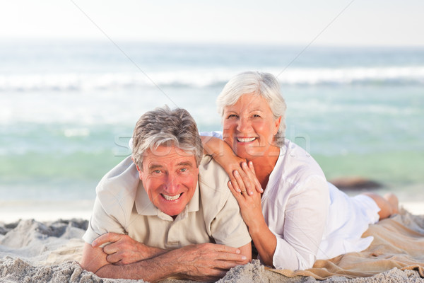 Elderly couple lying down on the beach Stock photo © wavebreak_media