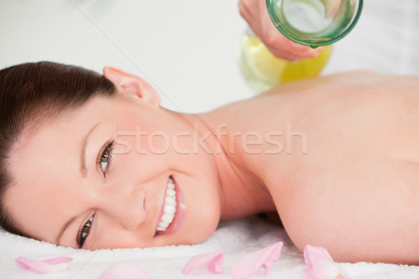 Close up of a woman having massag oil versed on her back Stock photo © wavebreak_media