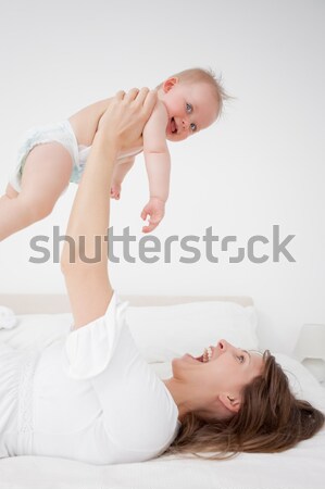 Blonde woman squatting on a weighing machine in her bedroom Stock photo © wavebreak_media