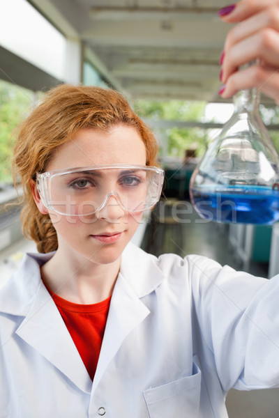 Portrait of a science student holding a flask with protective glasses Stock photo © wavebreak_media