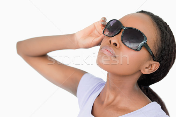 Close up of young woman moving her sunglasses against a white background Stock photo © wavebreak_media