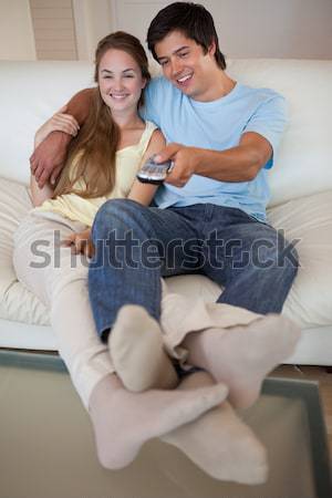 Portrait of a relaxed couple watching television in their living room Stock photo © wavebreak_media