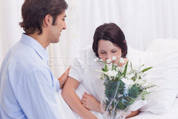 Young man brought flowers to his girlfriend in the hospital Stock photo © wavebreak_media