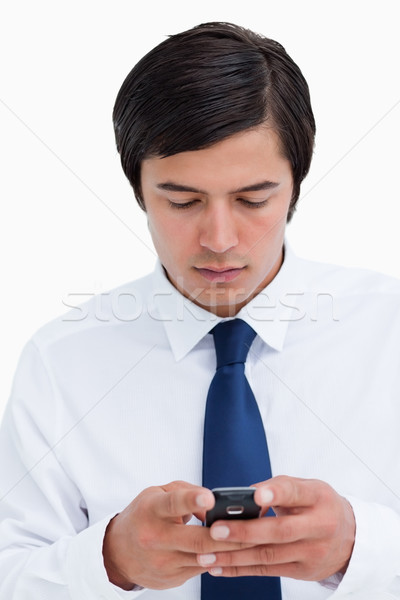 Stock photo: Close up of tradesman reading text message against a white background