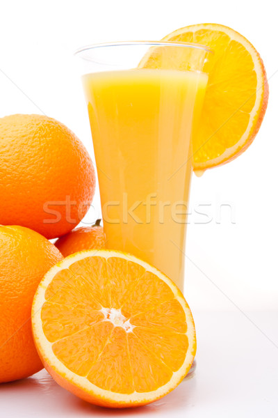 Pile of oranges near a glass of orange juice Stock photo © wavebreak_media