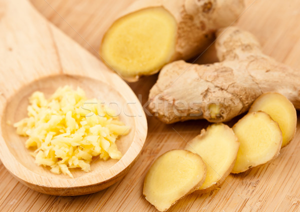 Piece slice and crushed of ginger against a wood worktop Stock photo © wavebreak_media