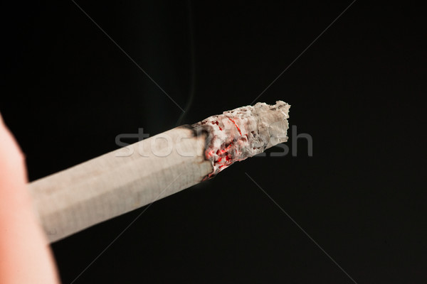 Someone smoking  against a black background Stock photo © wavebreak_media
