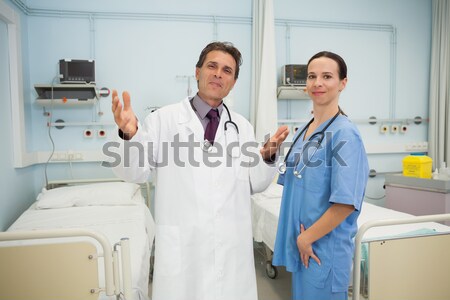 Doctor and nurse smiling in hospital bedroom Stock photo © wavebreak_media