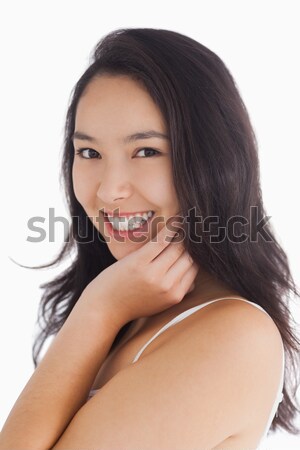 Female beauty smiling while touching her skin Stock photo © wavebreak_media