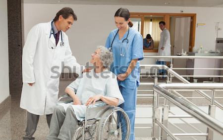 Doctor wheeling a patient in a wheelchair Stock photo © wavebreak_media