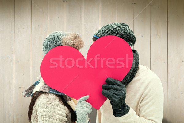 Composite image of attractive young couple in warm clothes holdi Stock photo © wavebreak_media