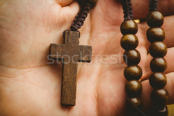 Hand holding wooden rosary beads Stock photo © wavebreak_media