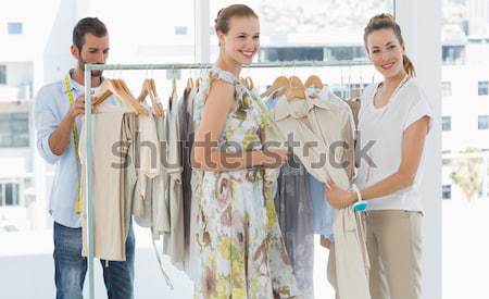 Seller helping shopper choose clothes in store  Stock photo © wavebreak_media