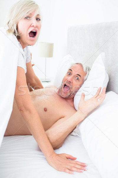 Portrait of mature couple shouting in bed Stock photo © wavebreak_media