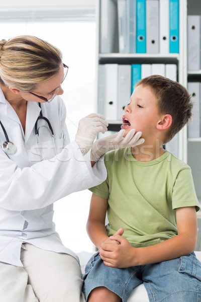 Doctor examining mouth of little boy Stock photo © wavebreak_media