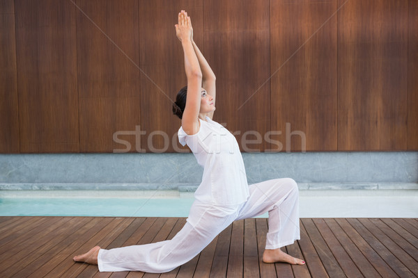 Content brunette in white doing tai chi Stock photo © wavebreak_media