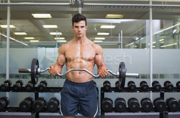 Stock photo: Shirtless muscular man lifting barbell in gym