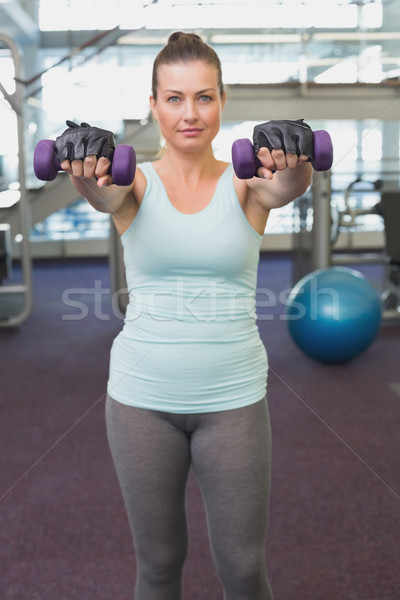 Fit brunette working out with dumbbells  Stock photo © wavebreak_media