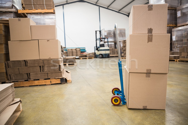 Stock photo: Boxes on trolley in warehouse