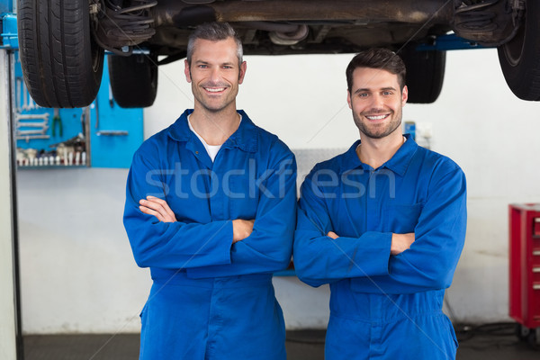 Team of mechanics smiling at camera Stock photo © wavebreak_media