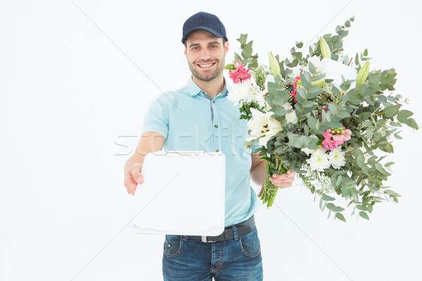 Flower delivery man showing clipboard Stock photo © wavebreak_media