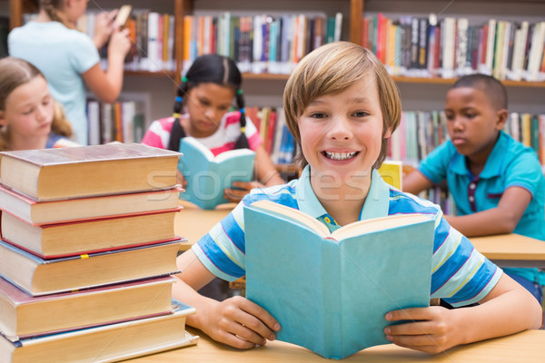 Cute pupils reading in library Stock photo © wavebreak_media