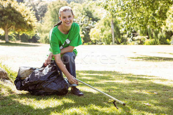 Stock photo: Environmental activist picking up trash