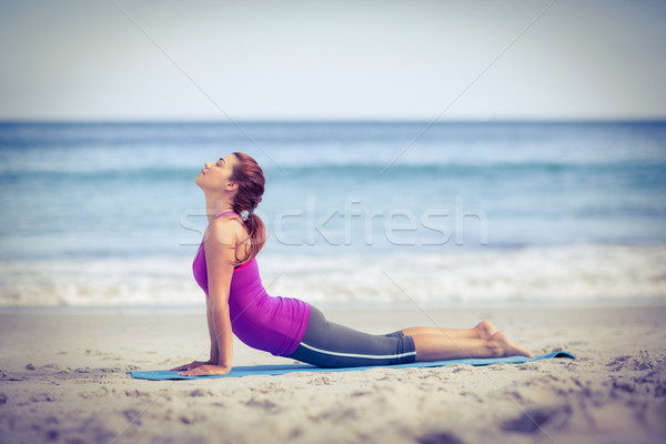 Brunette doing yoga on exercise mat Stock photo © wavebreak_media