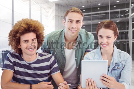 Stock photo: Business people smiling and working together with a laptop