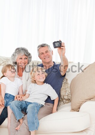 Stock photo: Cheerful family taking self pictures with a smartphone