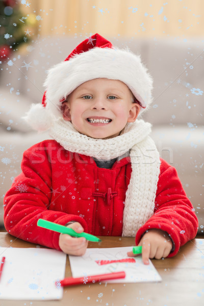 Composite image of festive little boy drawing pictures Stock photo © wavebreak_media