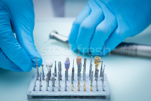 Gloved hands picking dental tools Stock photo © wavebreak_media