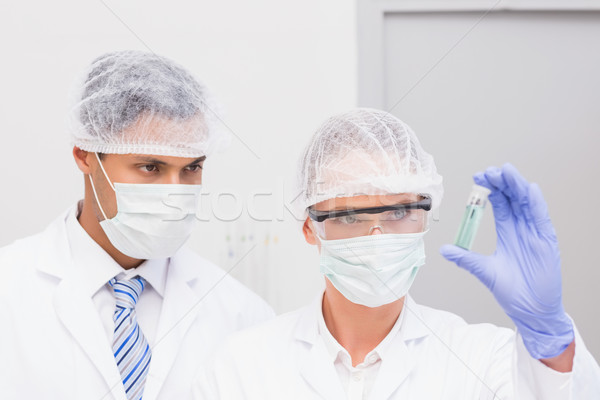 Scientists examining green precipitate in tube  Stock photo © wavebreak_media