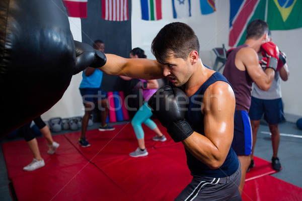 Young male boxer punching bag Stock photo © wavebreak_media