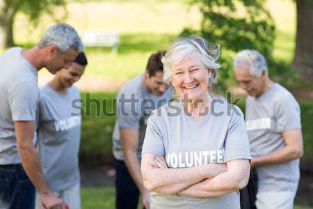 Senior woman with closed eyes meditating while sitting with friends Stock photo © wavebreak_media