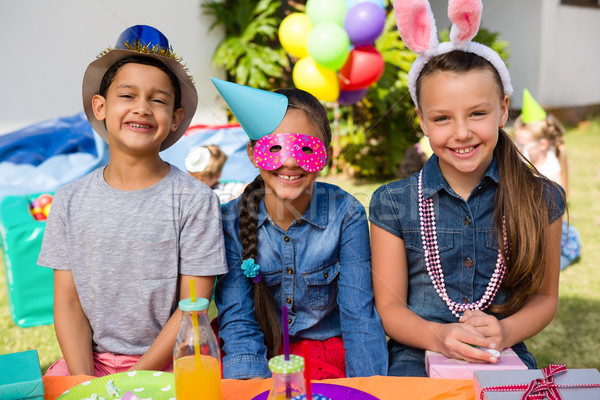 Portrait of happy children sitting at table Stock photo © wavebreak_media