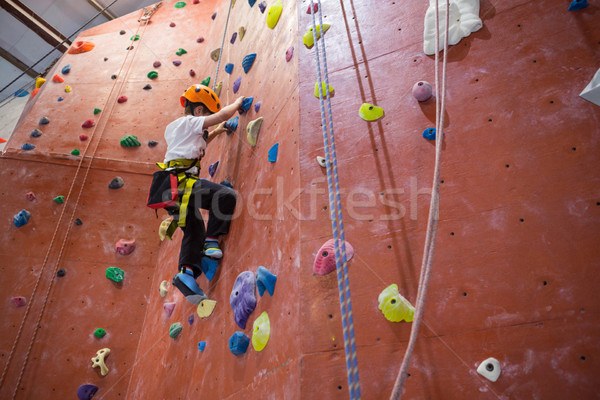 Stock photo: Determined boy practicing rock climbing
