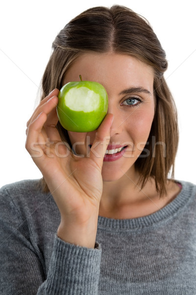 Portrait of woman holding granny smith apple against white background Stock photo © wavebreak_media