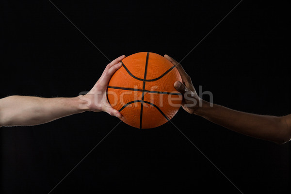 Competitors holding basketball against black background Stock photo © wavebreak_media